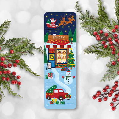 Christmas-themed bookmark with Santa, reindeer, and a bakery on a snowy background.