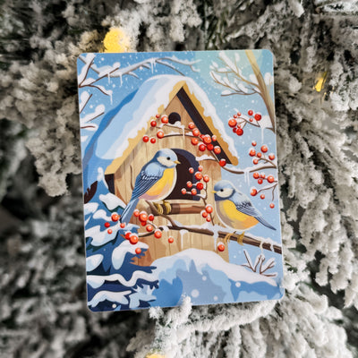 Card with a winter scene featuring birds and a birdhouse on a snowy branch.