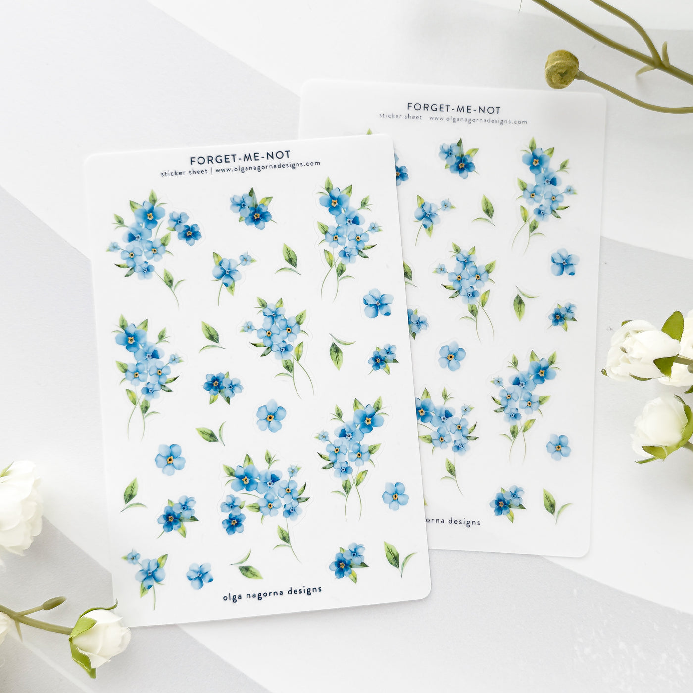 Two sheets of blue floral stickers with 'Forget-Me-Not' text on a white background.