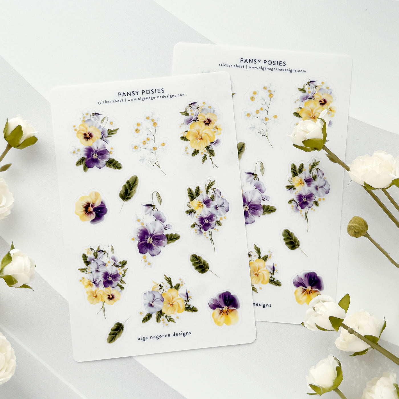 Floral sticker sheets with pansy posies on a white background.