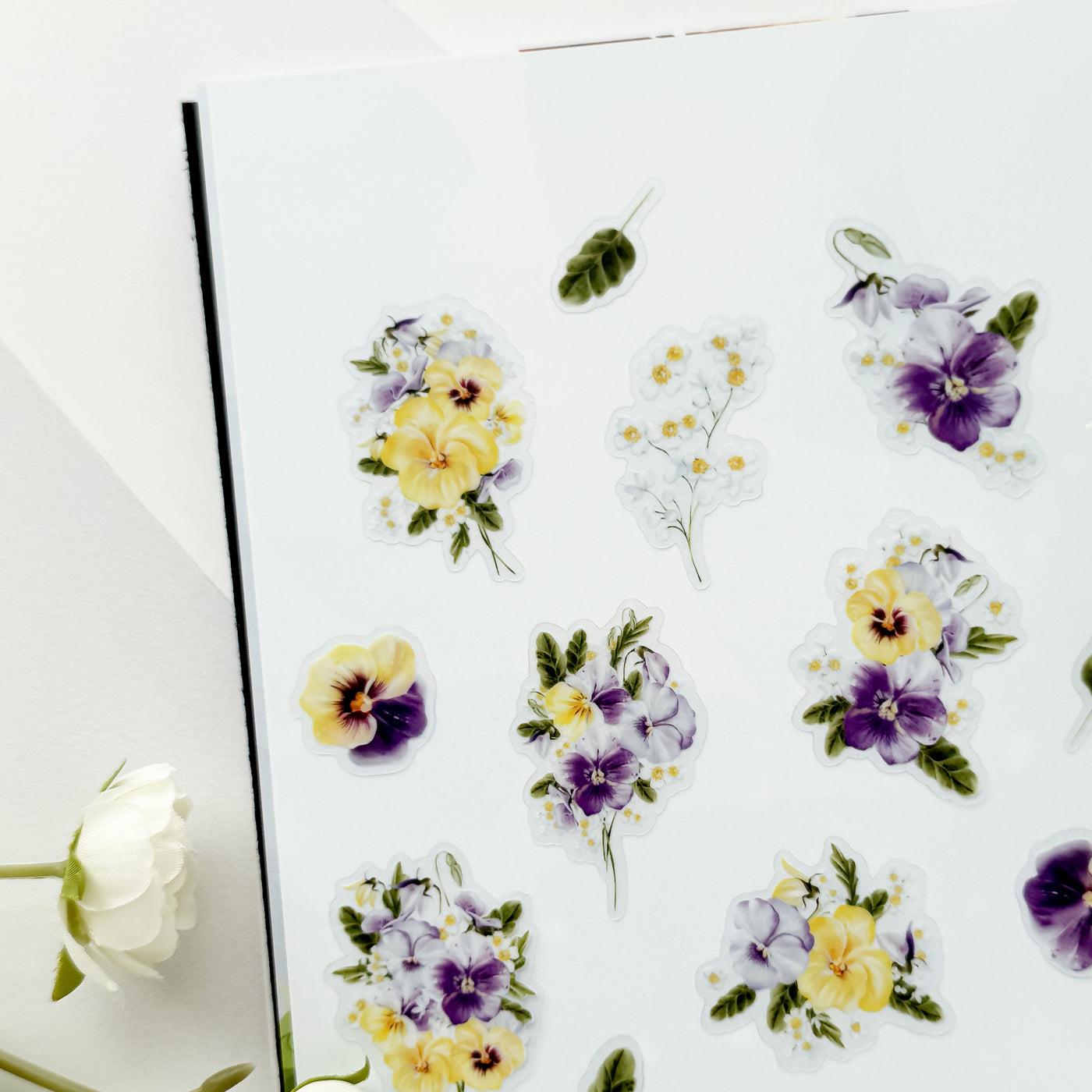 Floral stickers with yellow and purple flowers on a white background.