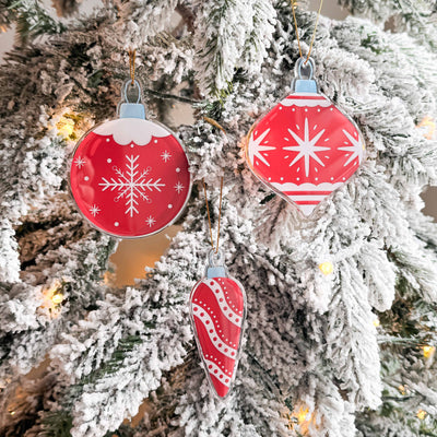Red and white Christmas ornaments on a decorated tree.
