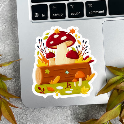 Sticker with mushrooms and leaves on a laptop keyboard.