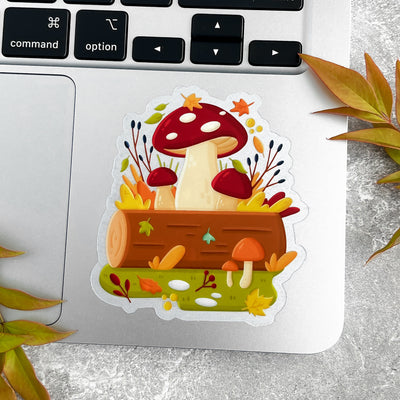 Sticker with mushrooms and a log on a laptop.