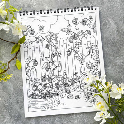 Coloring book page with garden design on a gray surface with flowers.