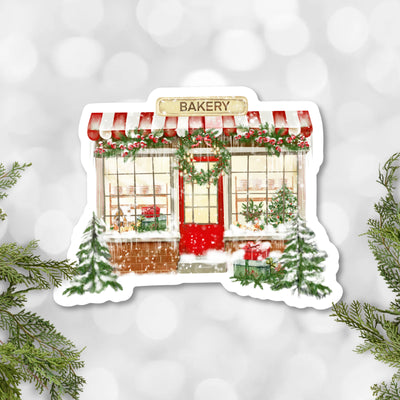 Illustration of a bakery with a red door and festive decorations on a snowy background.
