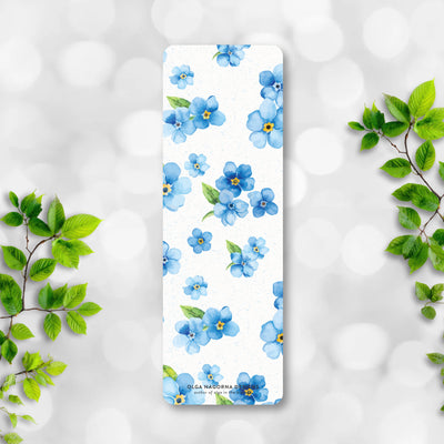 Bookmark with blue floral design on a white background with green leaves.