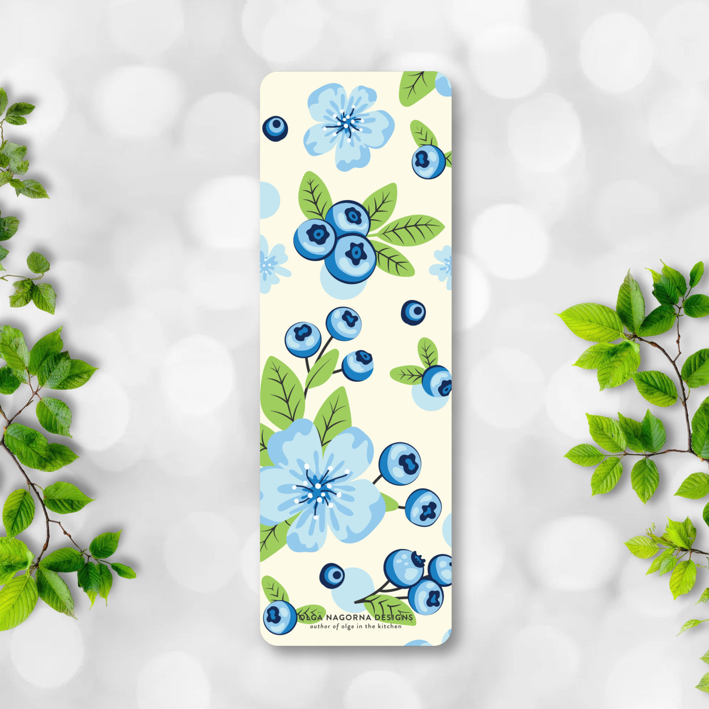 Bookmrak with blue floral and berry design on a light background.
