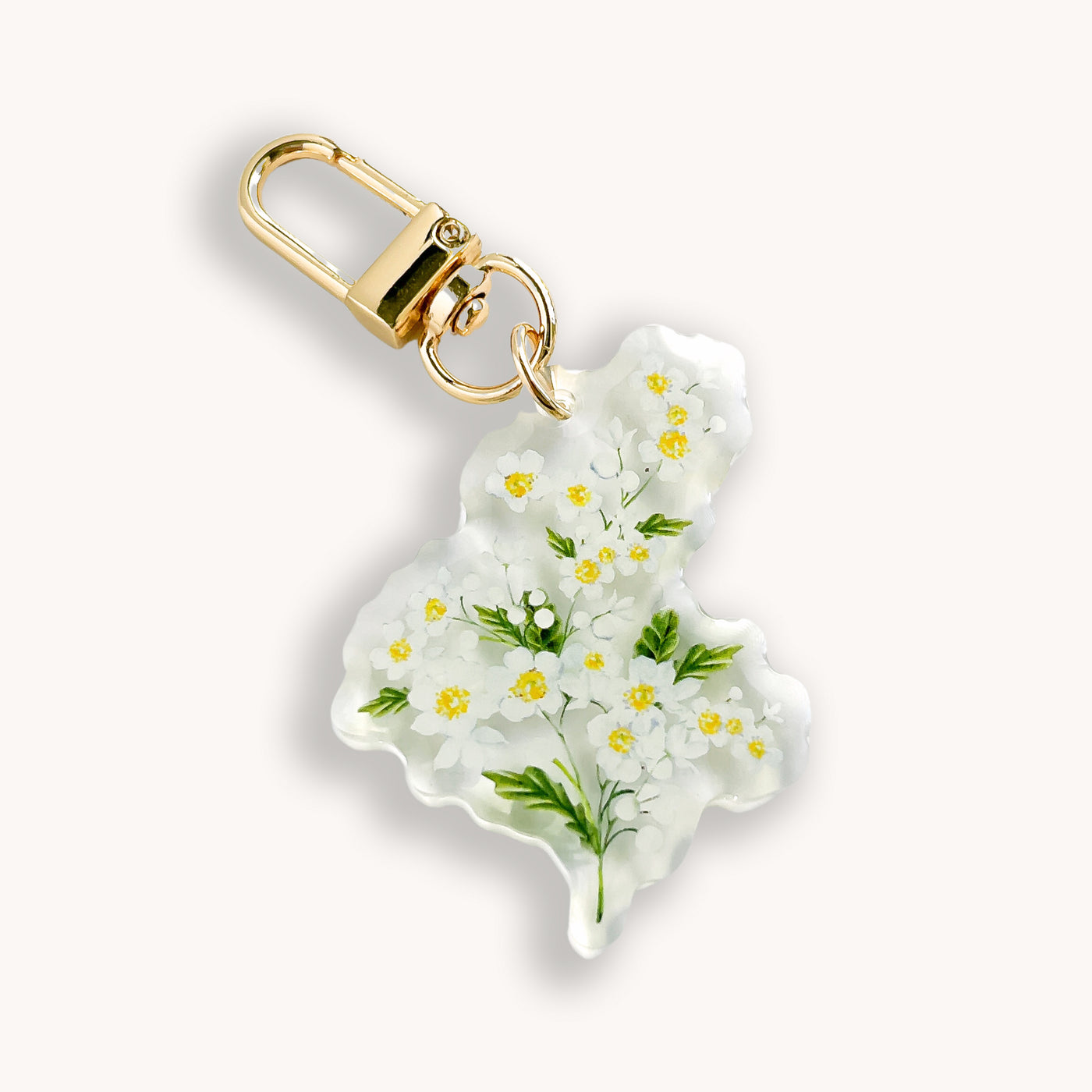 Keychain with floral design on a white background.