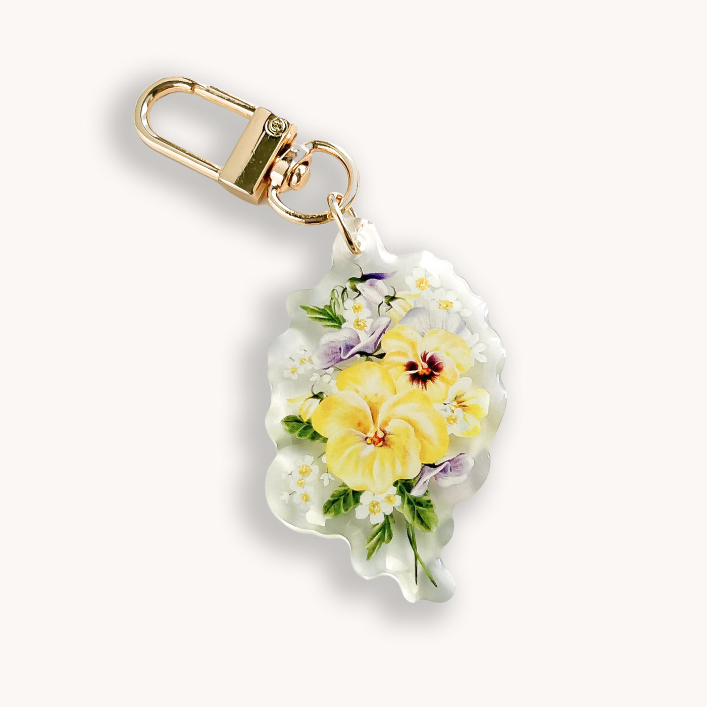 Floral keychain with gold clasp on a white background.