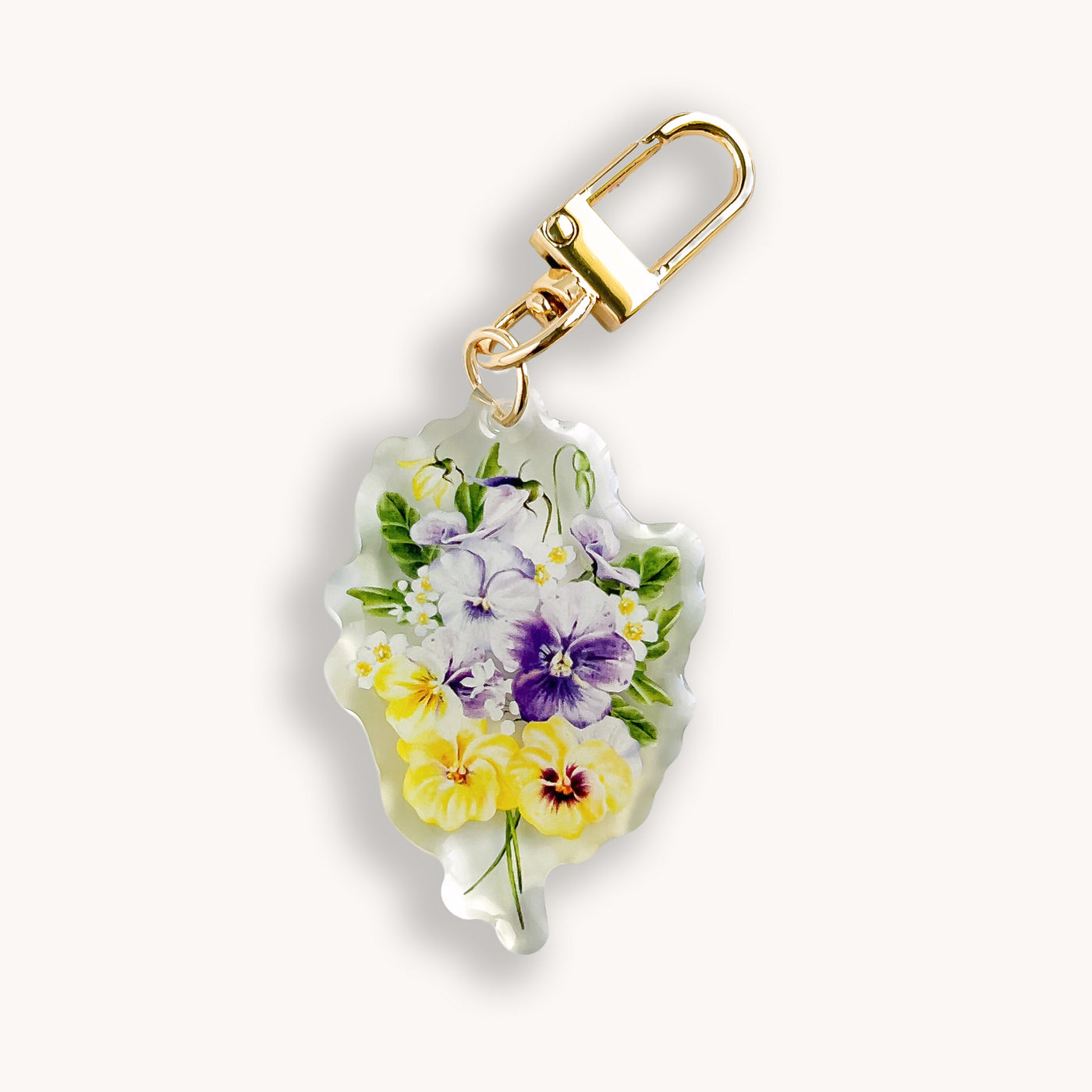Floral keychain with a gold clasp on a white background.