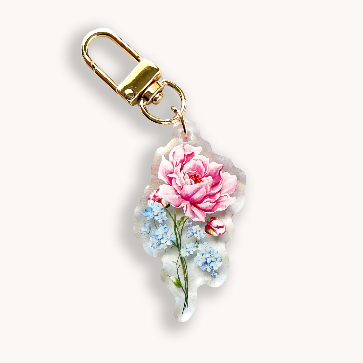 Keychain with pink flower design on a white background.
