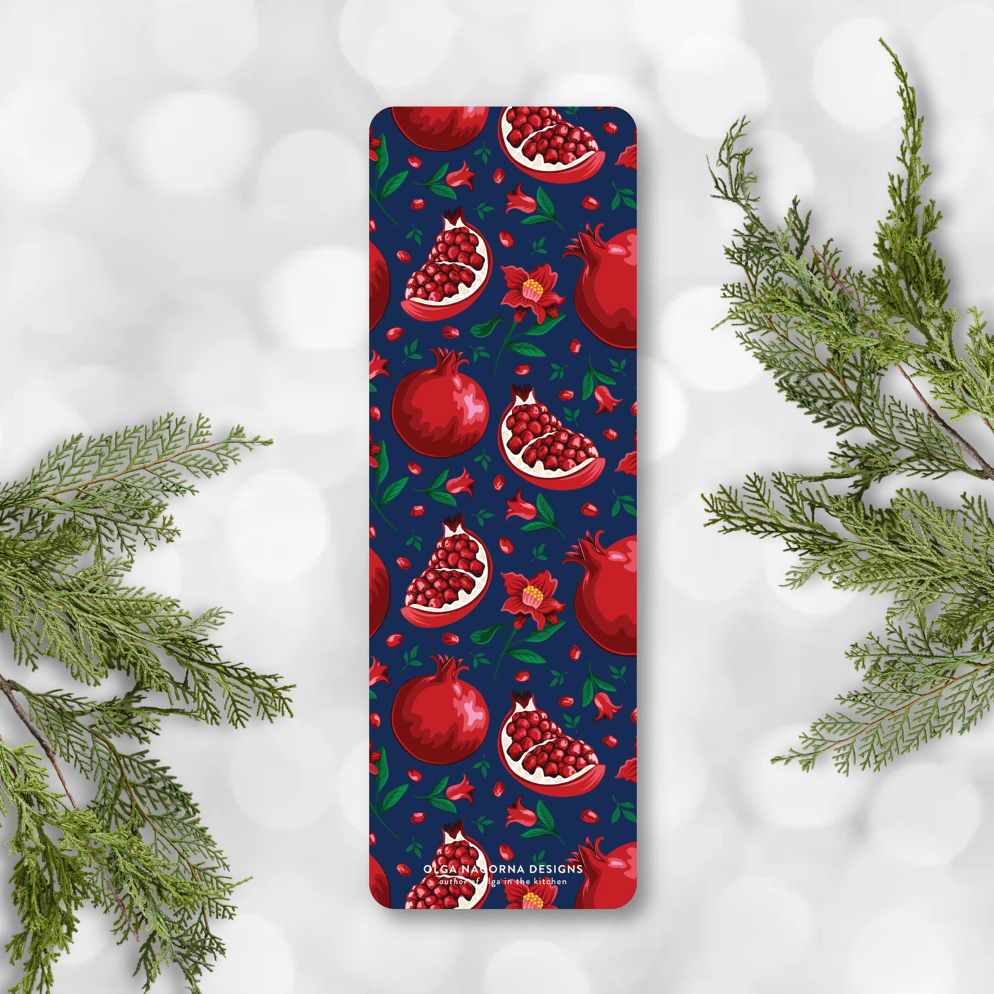Bookmark with pomegranate design on a white background with greenery.