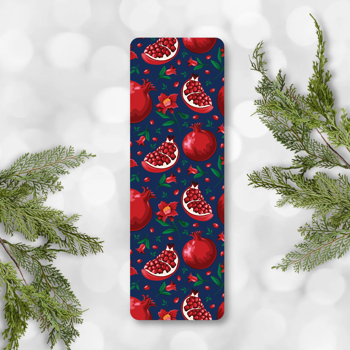 Bookmark with pomegranate pattern on a snowy background.