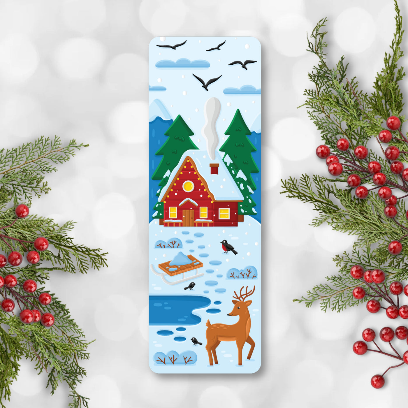 Decorative bookmark with a winter scene featuring a cabin, trees, and a deer, surrounded by Christmas decorations.