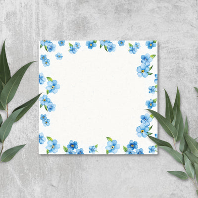 Sticky notes with blue floral border on a gray background.