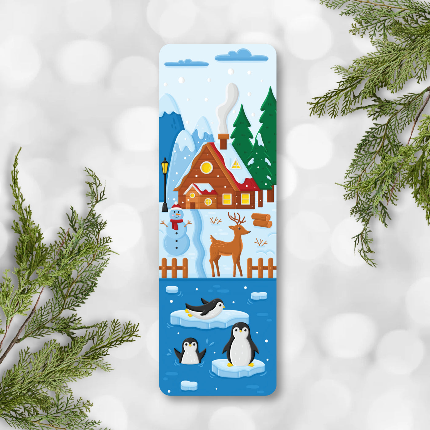 Decorative bookmark with winter scene featuring a house, trees, penguins, and a reindeer on a snowy background.