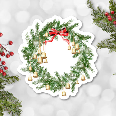 Christmas wreath with red bow and gold bells on a light gray background.